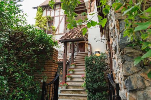 a stairway leading to a house with a gate at Le Charcoa Hotel in Chiang Mai