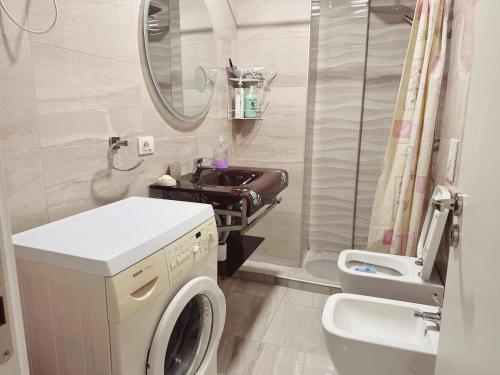 a bathroom with a washing machine and a sink at Smart Rent Apartment in Tirana
