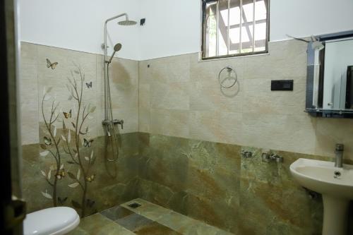 a bathroom with a shower and a sink at Dream Next in Mirissa