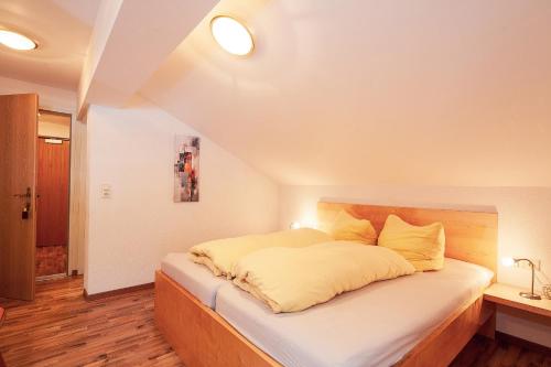 a bedroom with a large bed with yellow pillows at HOLIDAY Apartments in Jerzens
