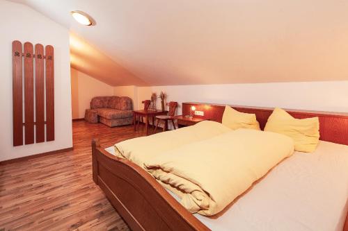 a bedroom with a bed and a chair in a room at HOLIDAY Apartments in Jerzens