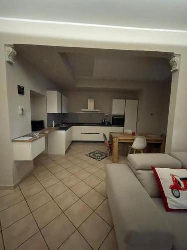 a living room with a couch and a kitchen at La piccola Flo in Terni