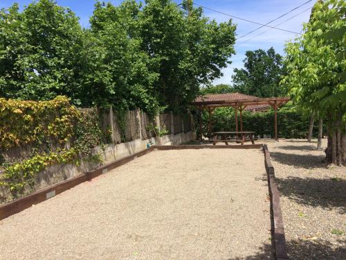 a picnic area with a bench and a gazebo at Le Piquet Résidence-Pavillon in Cazaubon