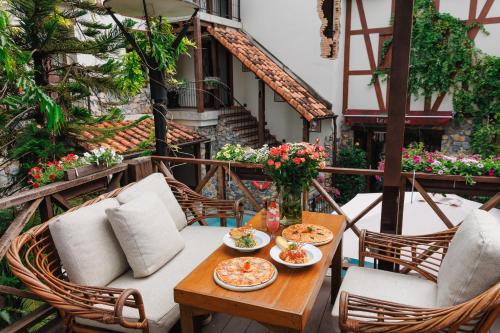 a table with two plates of food on a balcony at Le Charcoa Hotel in Chiang Mai