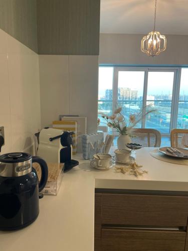 a kitchen with a counter with a coffee maker on it at Coral Holiday Home in Abu Dhabi