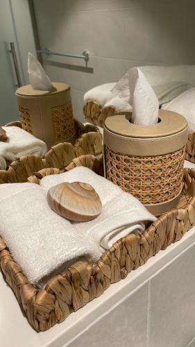 two baskets with towels and a bread on a table at Coral Holiday Home in Abu Dhabi