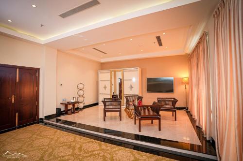 a living room with a couch and a tv at The Grand Mountain Hotel in Matale