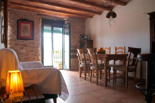 a living room with a table and chairs and a dining room at LA CASA DE LA PARRA in Ulldecona