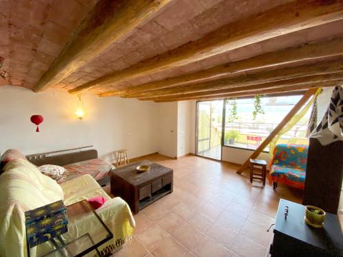 a living room with a couch and a table at LA CASA DE LA PARRA in Ulldecona