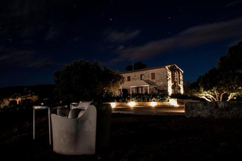 a house at night with lights in front of it at Poggio di Sole in Lacona