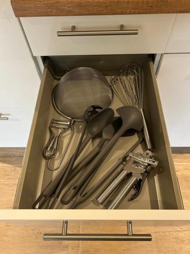 a drawer filled with utensils in a kitchen at Am Wehr Rheine in Rheine