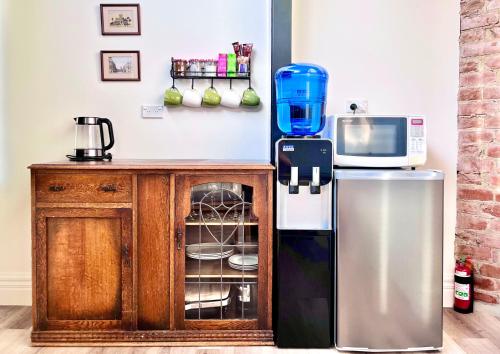 a kitchen with a refrigerator and a microwave at Opoho Heritage Guest Suite in Dunedin