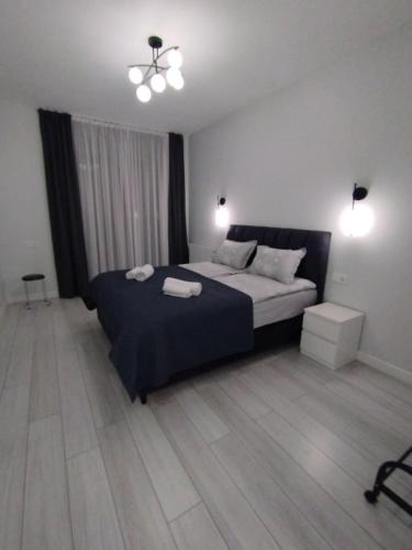 a bedroom with a bed with two towels on it at Tina's home in Batumi