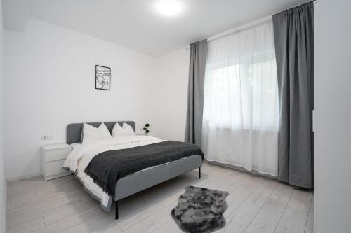 MăgureleにあるVila Magurele 5のベッドと大きな窓のある寝室