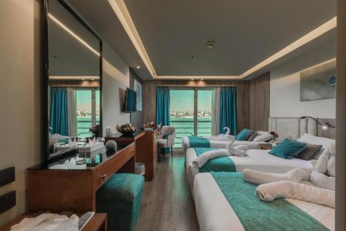 a hotel room with two beds and a mirror at Five Stars Nile Cruise from Luxor to Aswan 4 nights included sightseeing in Aswan