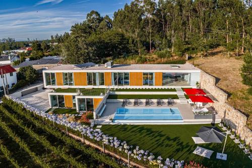 an aerial view of a house with a swimming pool at "Villa Carpe Diem" Country house in Cambarinho