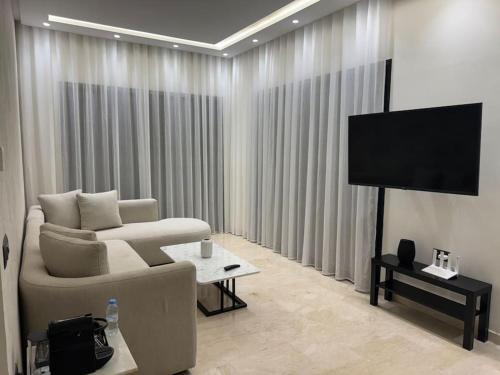 a living room with a couch and a flat screen tv at 48 Luxury Adam -Corniche à 5 min - smart TV in Casablanca