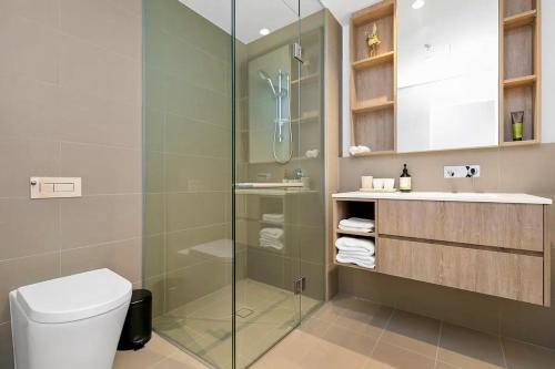 a bathroom with a glass shower and a toilet at Luxury apartment in Melbourne in Melbourne