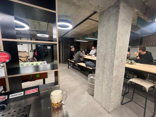 a group of people sitting at tables in a restaurant at Vibe Loft free drink daily by Zazi in Bratislava