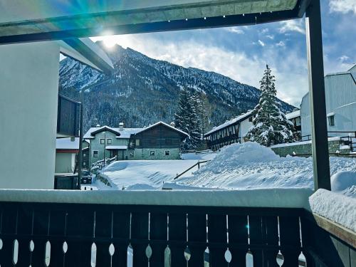 a view of a snow covered mountain from a balcony at Champoluc Apartment in Champoluc