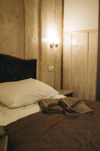 a bedroom with a bed with a blanket on it at SV HOTEL&camp in Lazeshchyna