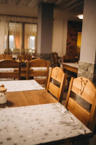 a dining room with tables and chairs withtorn at SV HOTEL&camp in Lazeshchyna