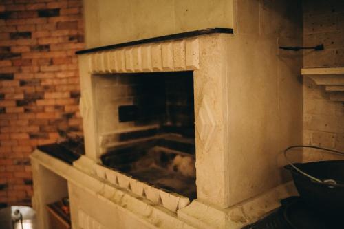 a stone fireplace in a brick wall at SV HOTEL&camp in Lazeshchyna