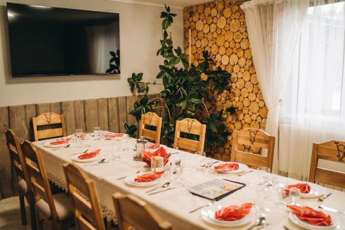 a long table with plates of food on it at SV HOTEL&camp in Lazeshchyna