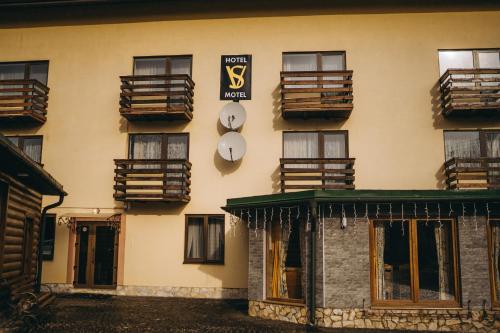 a building with clocks on the side of it at SV HOTEL&camp in Lazeshchyna