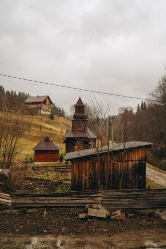 an old building and a church on a hill at SV HOTEL&camp in Lazeshchyna