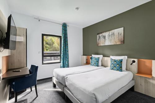 a bedroom with two beds and a desk and a tv at Hôtel Restaurant AKENA Molinges - La Brocatelle in Saint-Claude