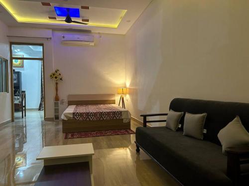 a living room with a bed and a couch at Urban Zen Oasis - Independent floor in City Centre in Gwalior