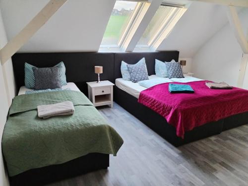 two twin beds in a room with windows at Hotel Radevormwald in Radevormwald