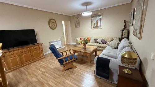 a living room with a couch and a flat screen tv at Torre Calera in Arganda del Rey