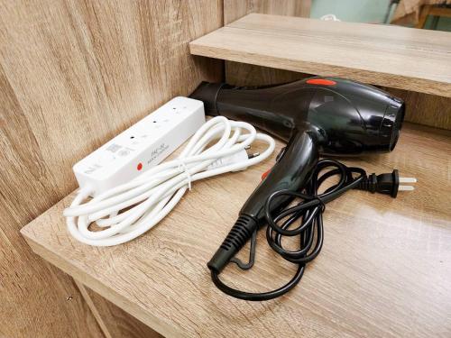 a hair dryer and a blow dryer on a table at 811-STP Homely room Free Wi-Fi and Near BTS Line in Bangkok