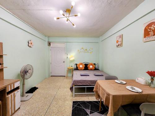a bedroom with a bed and a table in it at 811-STP Homely room Free Wi-Fi and Near BTS Line in Bangkok