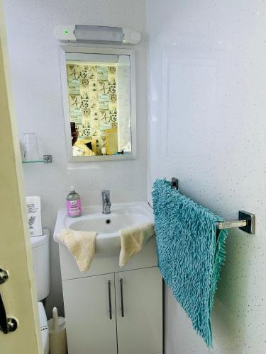 a bathroom with a sink and a mirror at Fairfax in Skegness