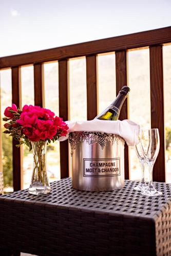 a bottle of champagne and flowers on a table at Hôtel Le Montaigu in Luz-Saint-Sauveur