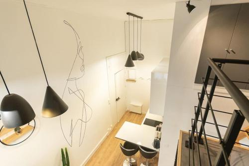 une chambre avec des lampes noires suspendues au mur dans l'établissement La Mezzanina - Hypercentre - Gare, à Angers