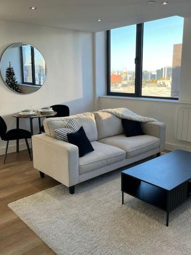 a living room with a white couch and a table at Stylish & Cosy One Bedroom Condo in Manchester