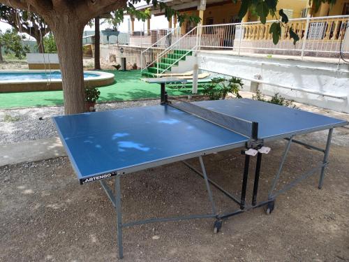 a ping pong table in front of a playground at turismo rural la solana in Murcia