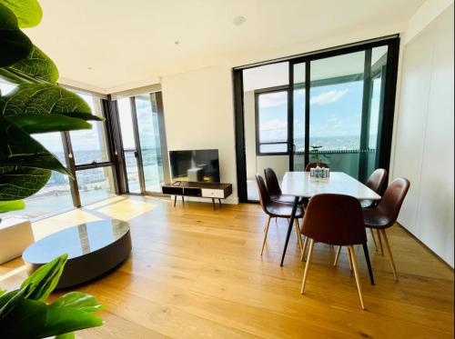 a dining room with a table and chairs at Brand New Waterview family residence 3 bedrooms -Pool, Parking in Sydney