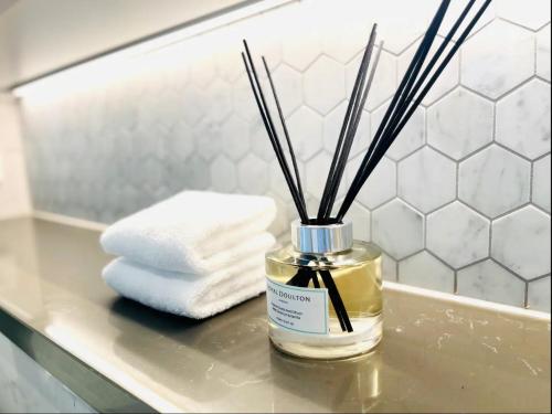 a bottle of perfume sitting on a table in a bathroom at Brand New Waterview family residence 3 bedrooms -Pool, Parking in Sydney
