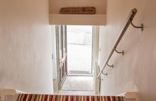 a stairwell with a window in a room at Rooftops - Sea Views Hot Tub Close to Beach in Saundersfoot