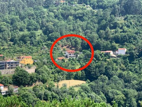 a house in a red circle on a mountain at Casa de Casarelhos - "Gerês" - Estúdio piso 0 - Apartamento Piso 1 in Geres