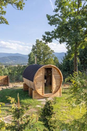 a small wooden house in a field with trees at Idea by Glamp in Wojcieszyce