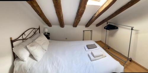 a bedroom with a bed with white sheets and pillows at COZY ROMANTIC MALASAÑA in Madrid