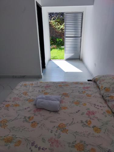 a bed with a pillow on it in a room at 11Suites casa Suite #7 in Caraguatatuba