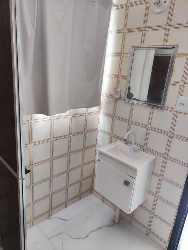 a bathroom with a sink and a mirror at 11Suites casa Suite #7 in Caraguatatuba