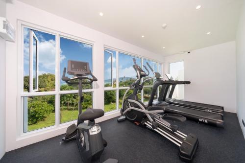 a gym with two exercise bikes and a treadmill at Chalong Marina Bay View Rawai Phuket in Rawai Beach